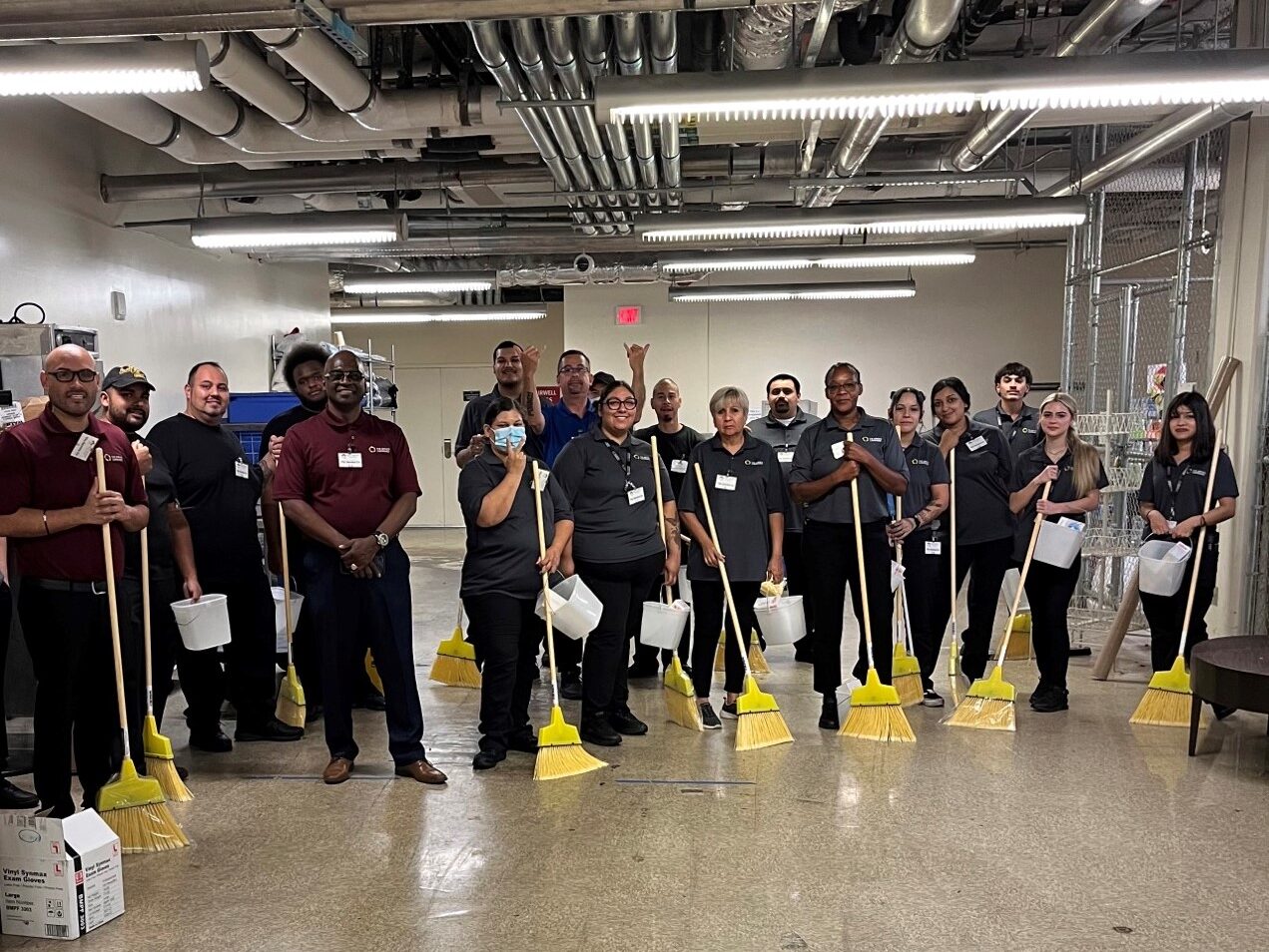 The-Service-Companies-Palm-Springs-casino-cleaning-team-smiling-with-brooms